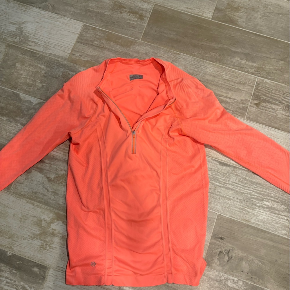 Athleta Orange long sleeved quarter zip running shirt.